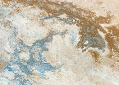Aerial view of swirling patterns of light and dark earth tones, creating a marbled effect across the landscape, Iceland.