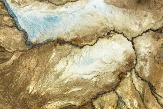 Aerial view of the stark, rugged earth, a tapestry of browns and creams etched with dark fissures and delicate lines, Reykjavik, Reykjavikurborg, Iceland.