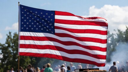 Obraz premium American flag waving at outdoor event with diverse crowd in background.
