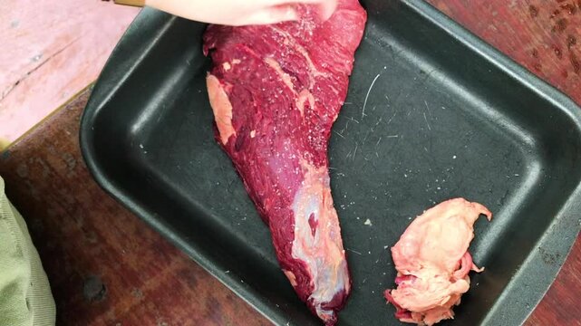 Raw Beef Being Salted for Barbecue &ndash; Homemade Asado Food Preparation in Kitchen