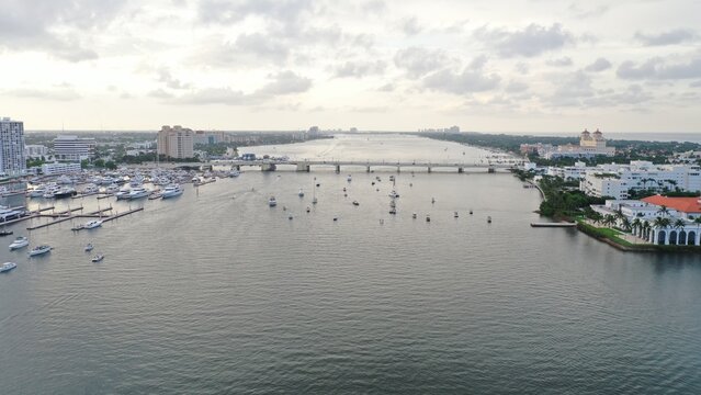 Aerial view of boats dotting the waterway under a bridge, contrasting with the buildings, Palm Beach, Florida, United States.