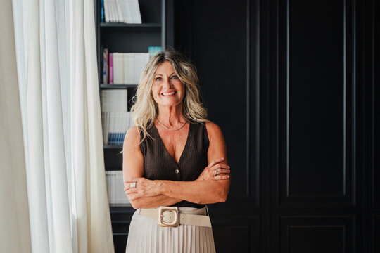 Stunning businesswoman stands by the window