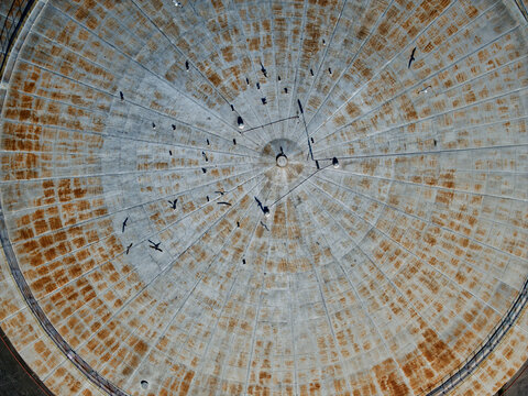 Aerial view of the weathered, circular structure with radiating lines creating a mesmerizing pattern, its aged texture telling stories of time, Kalochori, Thessaloniki, Greece.