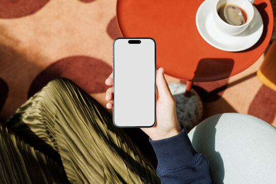 Hand Holding Smartphone Mockup Coffee on Red Table