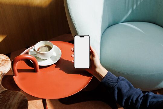 Smartphone White Screen Mockup Near Cup on Red Table