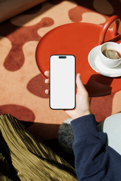 Phone Screen Mockup Above Red Table and Coffee