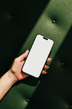 Mock-up phone with empty screen on green leather background
