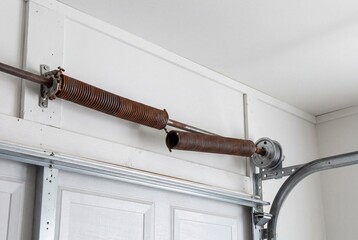 Naklejka premium Broken torsion spring on a residential garage door