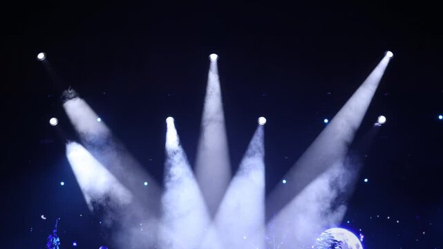 An empty stage of the theater, lit by spotlights and smoke before the performance
