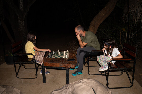 Chess Match in Progress on Wooden Table