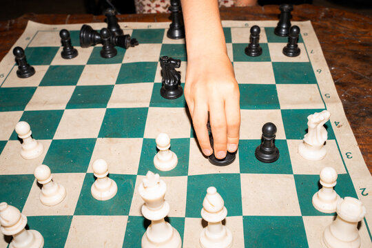 Chess Match in Progress on Wooden Table