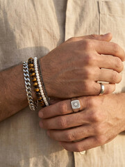 Hands wearing bracelets and rings show personal style and accessories