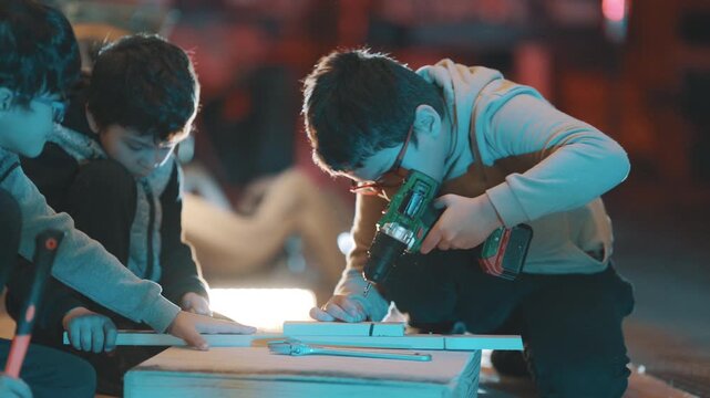 Children learning woodworking skills in a workshop
