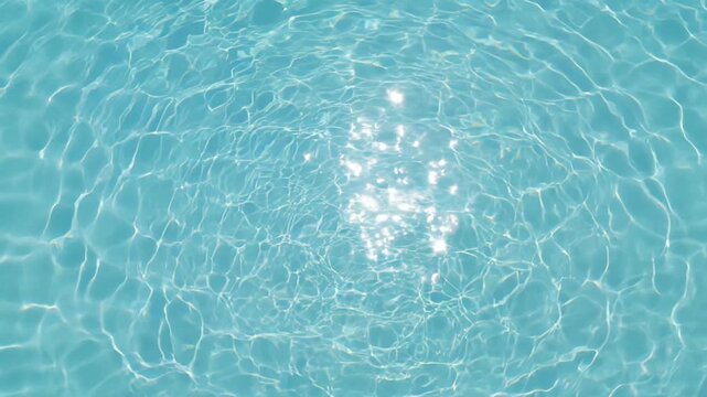 Static overhead shot of clear blue water rippling with sparkling sunlight reflections