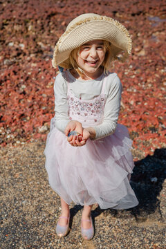 Little girl showing off a shell she found