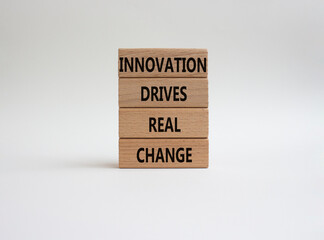 Naklejka premium Innovation symbol. Wooden blocks with words Innovation drives real change. Beautiful white background. Business and Innovation concept. Copy space