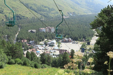 A view of the Cheget meadow and the cable car to Mount Cheget in the Caucasus Mountains on a sunny summer day