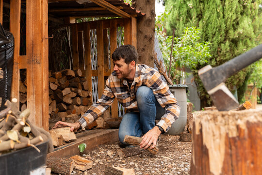 Man Stacking Firewood Logs