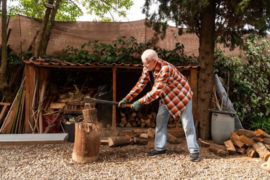 Senior Man Chopping Wood
