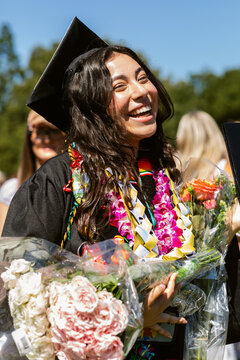 Graduating Student Celebrates With Flowers