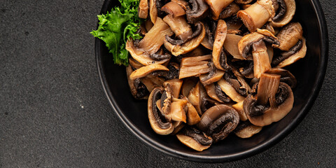 Fototapeta premium Champignon mushrooms ready to eat tasty snack fresh gourmet food background on the table rustic food top view copy space keto and paleo diet vegetarian and vegan food marketing concept photo