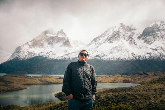 Patagonian mountains behind cheerful man