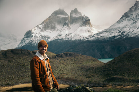 Smiling man in front of the Torres del Paine in Patagonia, Chile