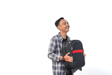 Fototapeta premium Asian man wearing a plaid shirt with a happy expression is holding a suitcase on an isolated white background.
