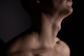 Naklejka premium young man's neck, adam's apple close-up. Concept: thyroid problems, sore throat from seasonal colds and viral infection