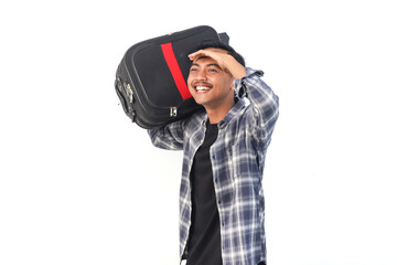 Asian man wearing a shirt with a hopeful expression is carrying a suitcase on an isolated white background.