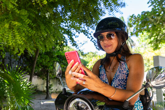 Woman travel with cell phone on scooter 