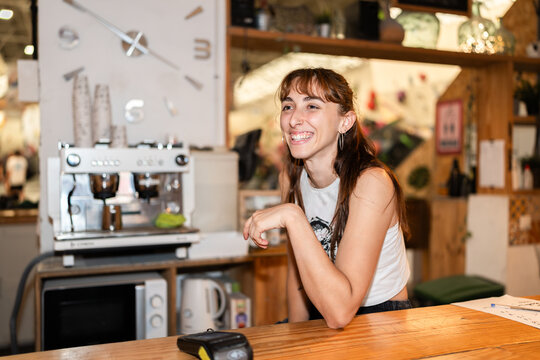 Happy woman smiling working in a coffee shop