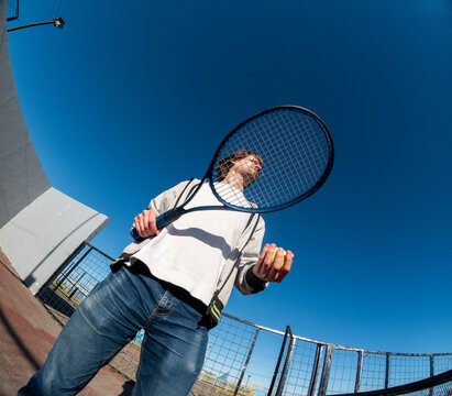 Holding a Tennis Racket and Preparing to Serve on the Court