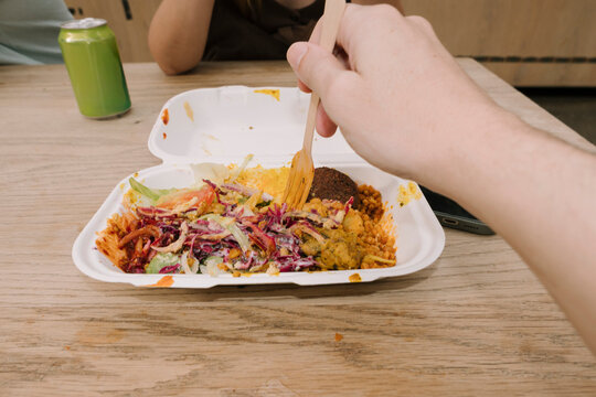 Hand holding fork over Turkish meal