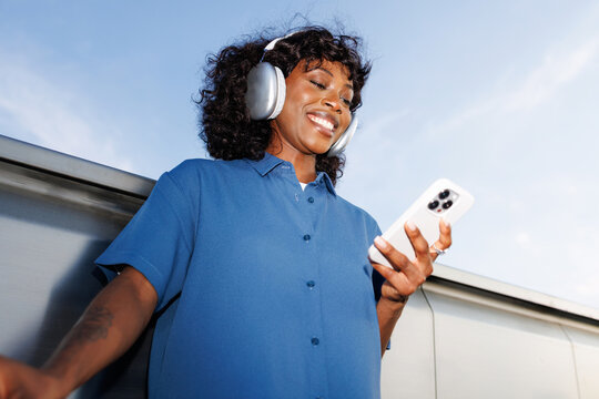 Portrait Smiling Woman Using Phone Under Blue Sky