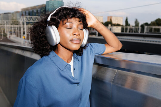 Woman Relaxing with Headphones in Transit