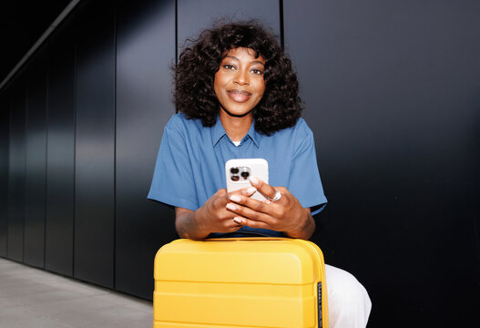 Portrait Stylish Traveler Woman with Yellow Luggage with flash 