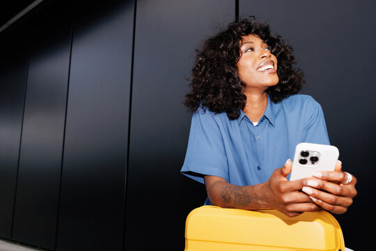 Portrait Woman Leaning On Suitcase With Phone