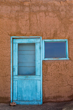 Taos, New Mexico, United States. Blue painted door on old adobe building. 