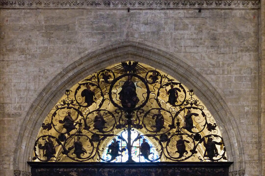 Seville, Spain. Detailed gothic iron work in stone arch