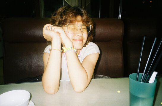 A happy girl on a dinning table