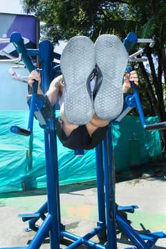 Fitness Enthusiast Practicing Leg Raises in Outdoor Gym Setup