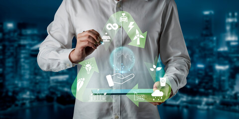 Person in White Shirt Holding Sustainable Energy Symbols with Digital Icons Representing Recycling,...