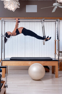 Pregnant Woman Hanging Horizontally On Cadillac Frame