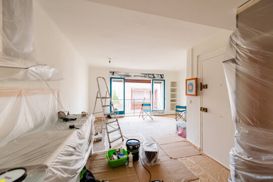 Living Room Covered with Protective Sheets During Painting