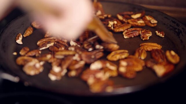 Roasting Pecan Nuts in Frying Pan. Ingredient Preparation for Gourmet Meal