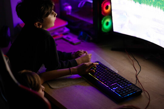 Kids Gaming on PC With RGB Keyboard and Colorful Monitor