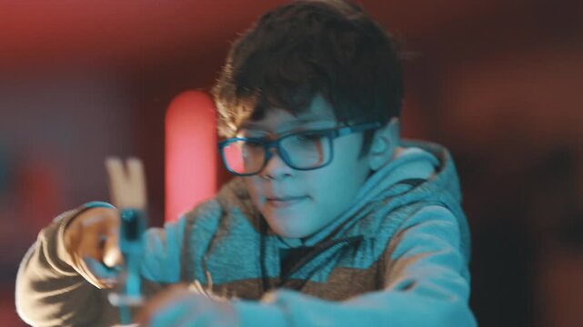 Young boy learning carpentry skills with hammer