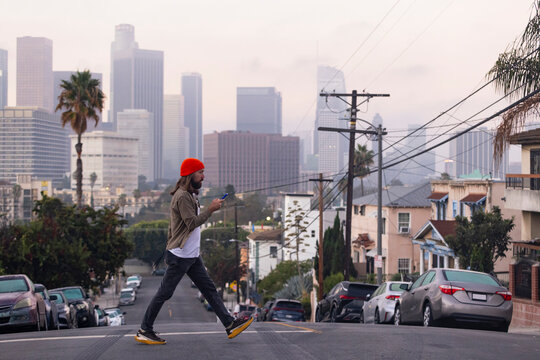 Man walking street city Los Angeles skyline 