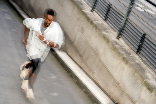 Man Running Fast in an Urban Setting During the Day